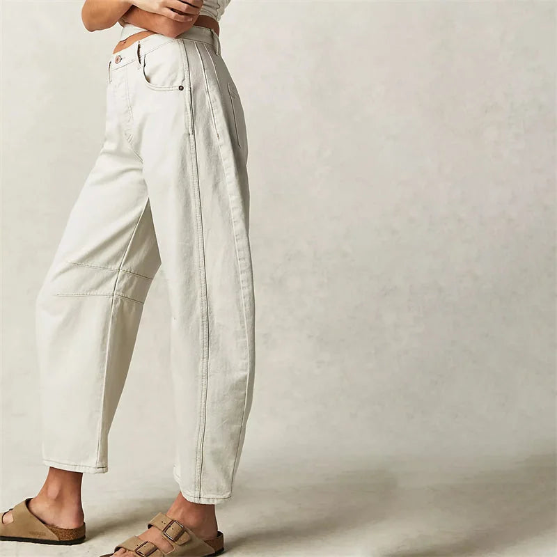 White Women's High-Waisted Barrel Leg Jeans — Dot Denim Curved-Seam Relaxed - Side Walking Pose
