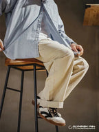 Beige Men's Classic Retro Sneakers with Lace-Up Closure & Suede Panels — Beau - Seated Styling Pose