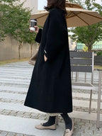 Women's Long Wool Coat with Collarless Neckline & Relaxed Fit - Back Walking