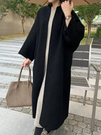 Black Women's Long Wool Coat with Collarless Neckline & Relaxed Fit - Worn Lifestyle