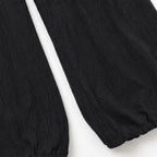 Black Women's Halter Neck Jumpsuit with Cowl Neckline & Wide-Leg Fit — Eva - Close Up Hem Leg