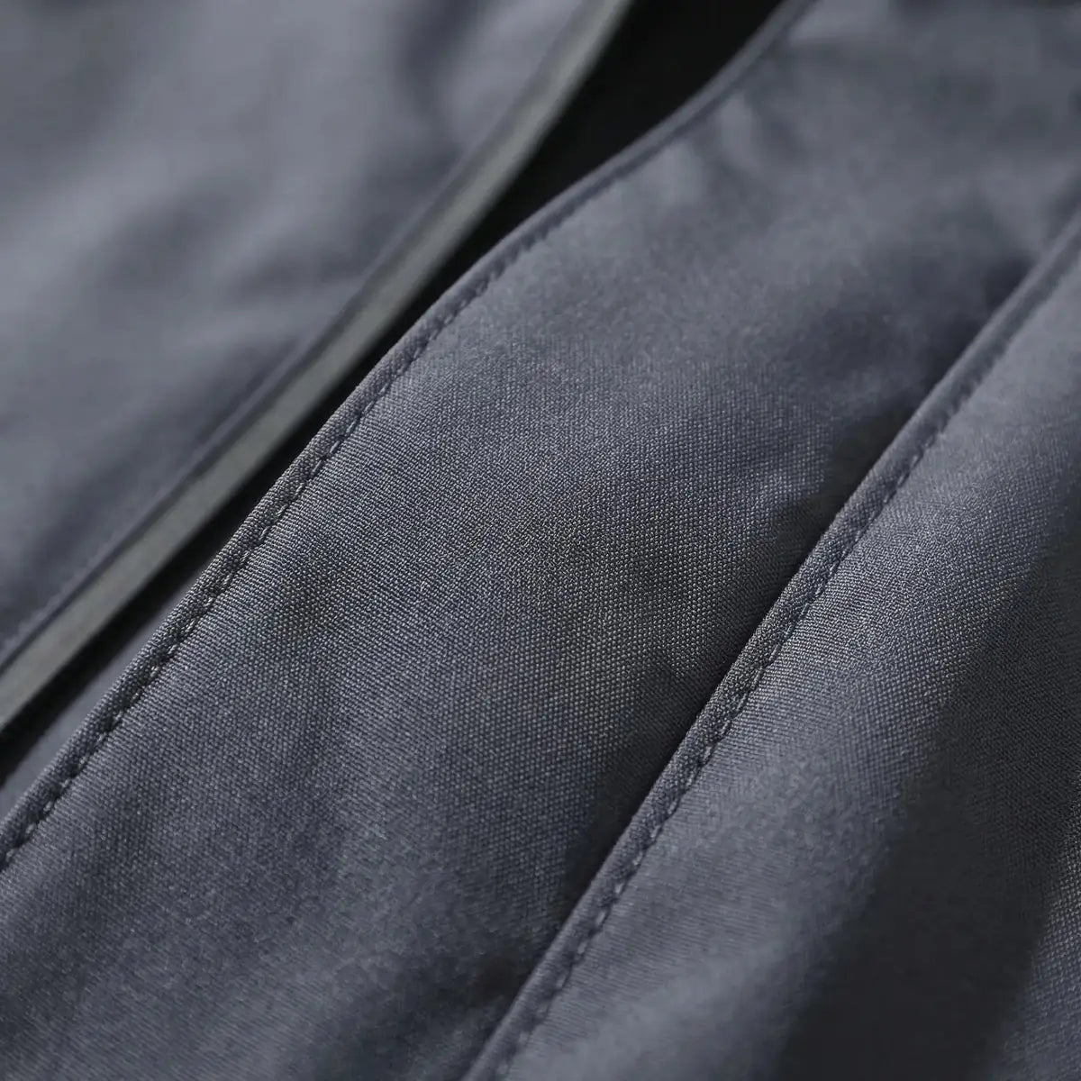 Gray Men's Hooded Waterproof Rain Jacket — Elle Nylon Zip-Pocket Adjustable Cuffs - Fabric Close Up