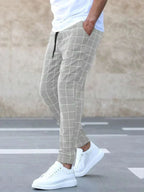 Men's Plaid Trousers with Drawstring Waist & Tapered Cuffed Fit - Walking Pose