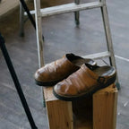 Beige Men's Leather Mules with Adjustable Buckle & Cushioned Footbed — Lincoln - Worn On Stool
