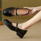 Black Women's Mary Jane Shoes with Adjustable Strap & Low Block Heel - Hand Holding Side