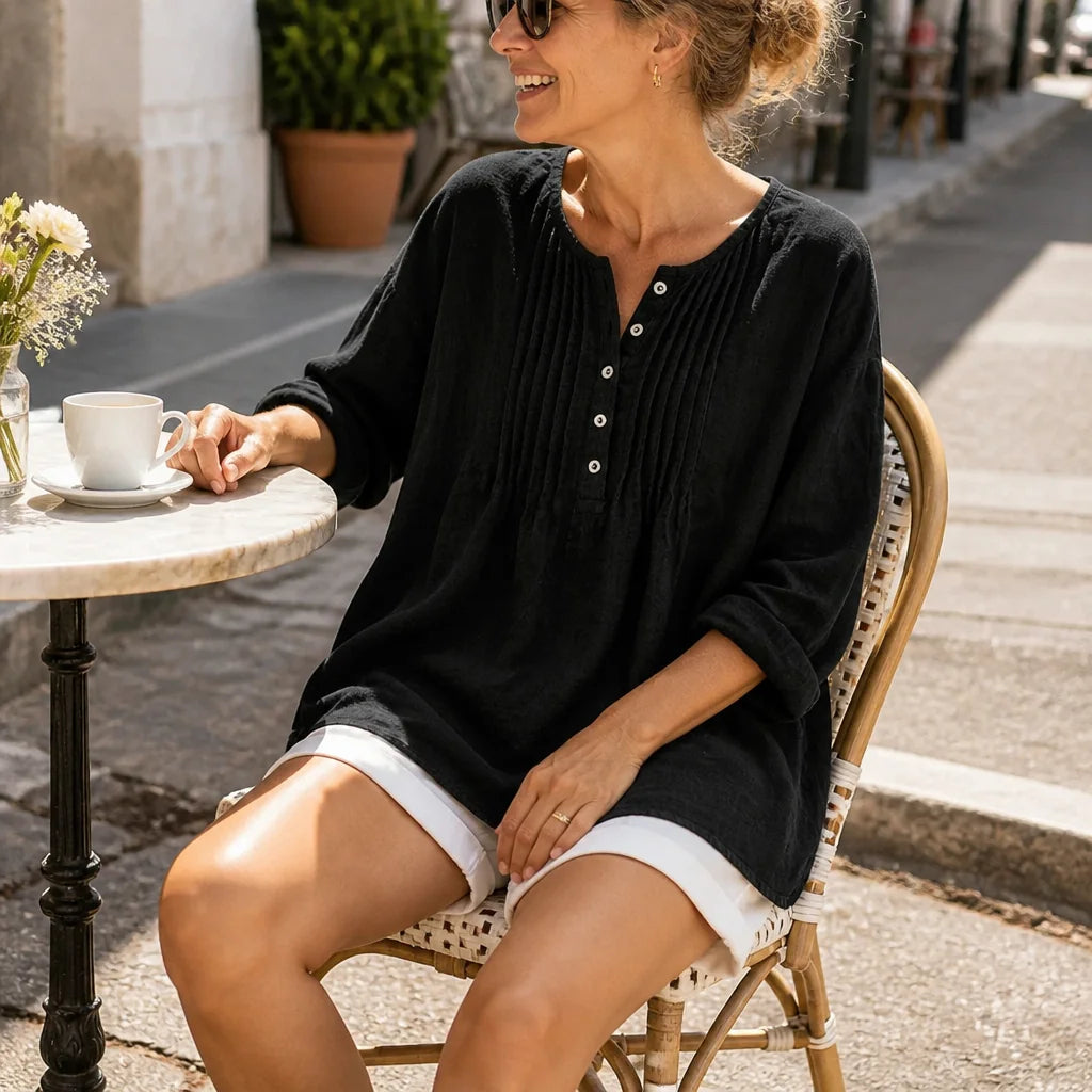 Black Women's Loose Fit Tunic Blouse with Pin-Tuck Detail & Breathable Comfort — Dora - Seated Cafe Table