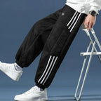 Men's Sherpa-Lined Jogger Pants with Striped Side Panels - Side Lean Detail