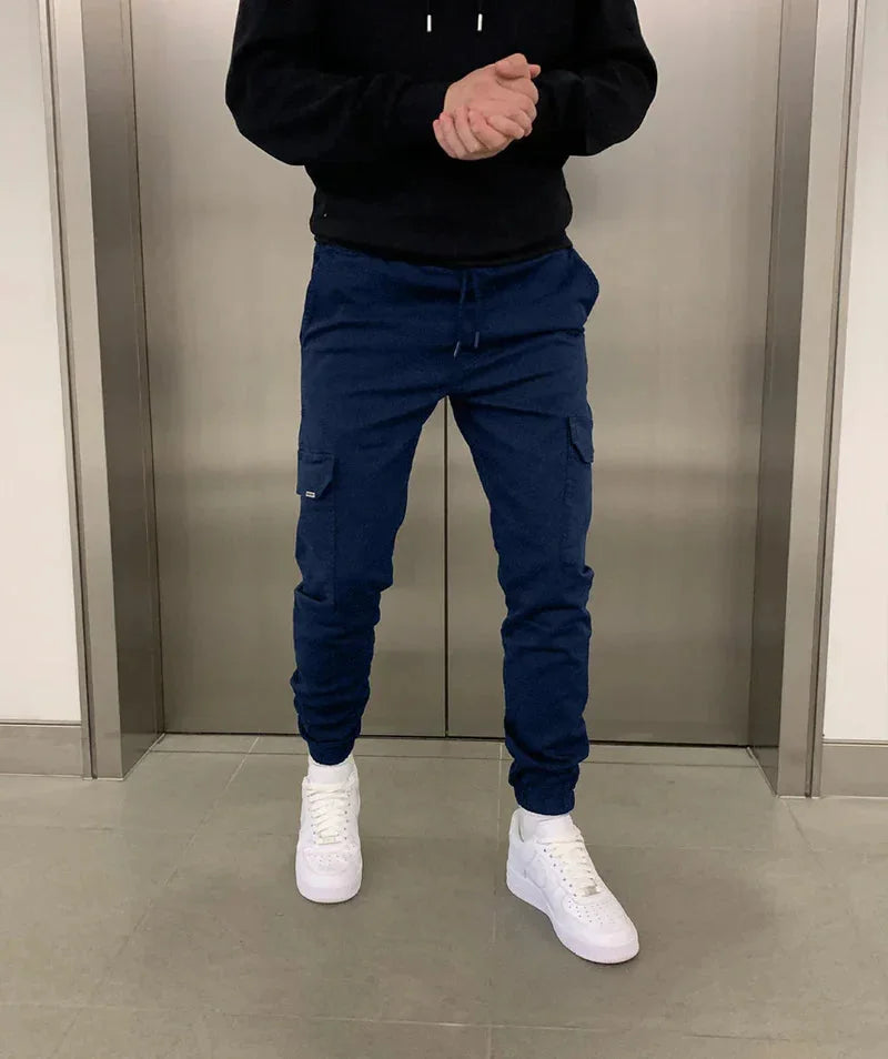 Navy Blue Men's Slim Fit Cargo Joggers with Drawstring Waist & Multi-Pocket Design — Harvey - Front Jump Pose