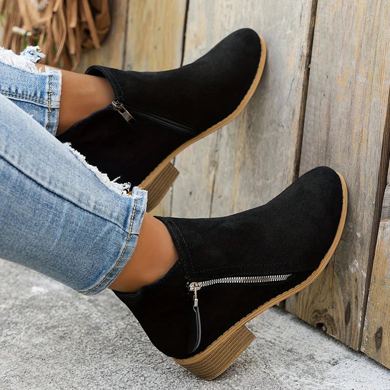 Black Women's Suede Ankle Boots — Tamsin Zip-Up Block Heel Pointed Toe - Leaning Against Wall