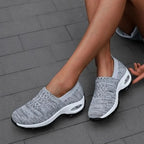 Light Grey Women's Slip-On Shoes with Cushioned Platform Sole & Breathable Knit Design - Side Seated Pose